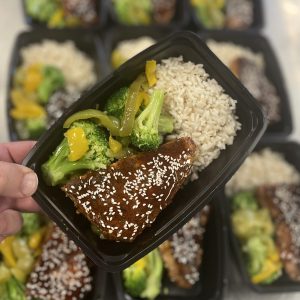 Seared Ahi Tuna Teriyaki over herbed rice and topped bell pepper and onion mix and broccoli