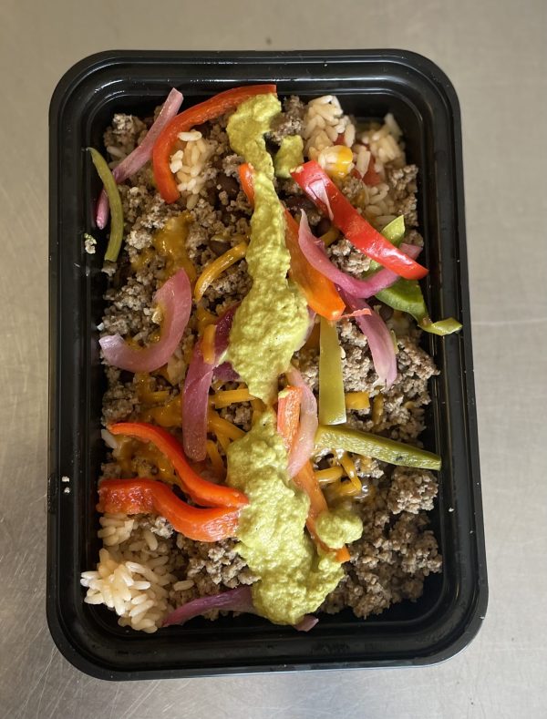 Ground Bison Taco Bowl with shredded cheese, black bean, bell peppers, herbed rice and salsa verde