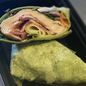 NEW GLUTEN FREE Turkey and Bacon Spinach Wrap with greens, tomato, red onion, swiss cheese and dijonnaise