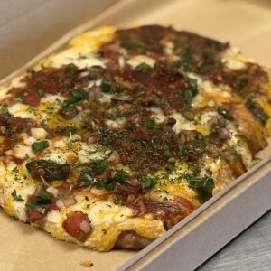 Mexican Protein Pizza with ground chicken crust, cottage cheese queso and pico de gallo