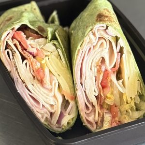 Spinach Club Wrap with turkey, ham, bacon, swiss cheese, dijonaisse, lettuce, tomato and onions
